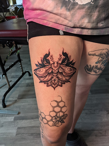 Work by Against the Grain Tattoo Studio