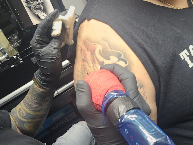 Work by Golden Cobra Tattoos and Piercings