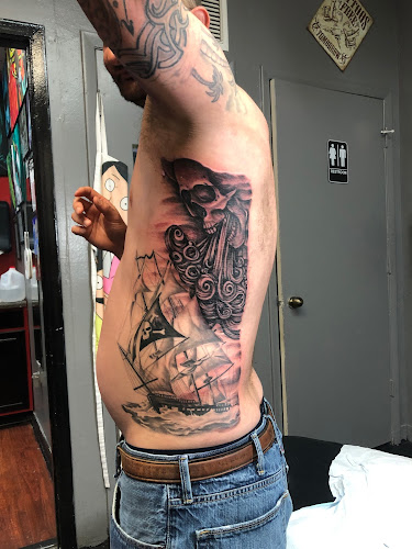 Work by Alchemy Tattoos and Body Piercings