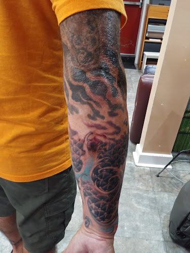 Work by No Ka Oi Tiki Tattoo