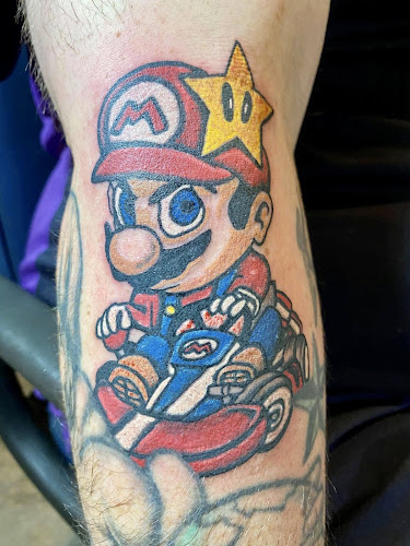 Work by Mad Hatter Tattoos